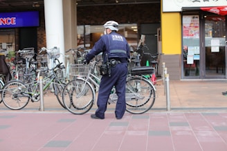 Police officer standing guard outside a school during morning drop-off.