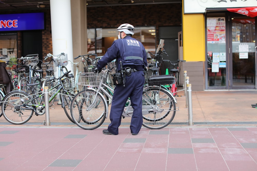 a police officer standing next to a bunch of bikes