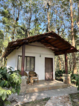 a small white house with a wooden roof