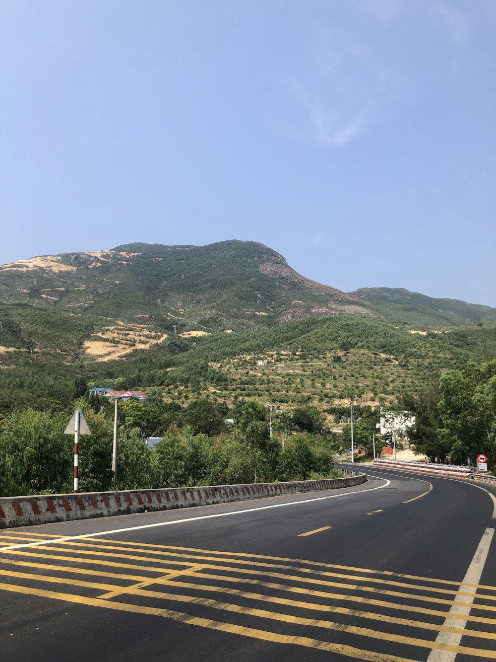 a road with a mountain in the background