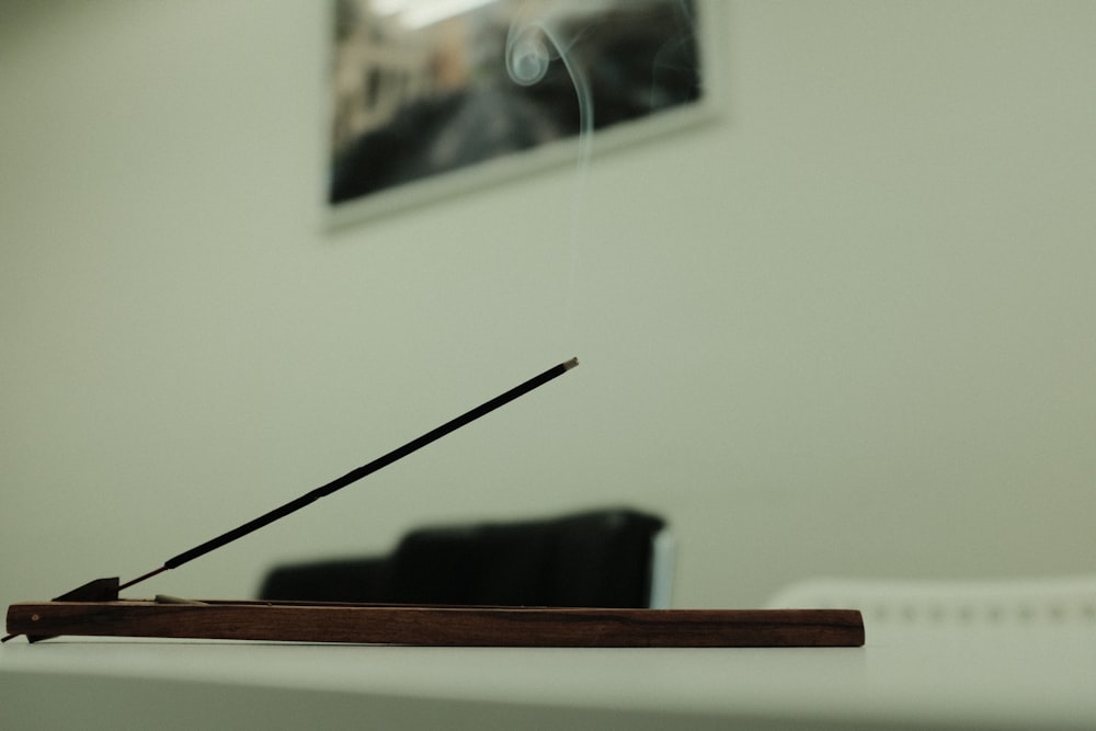 a close up of a wooden table with a black chair in the background