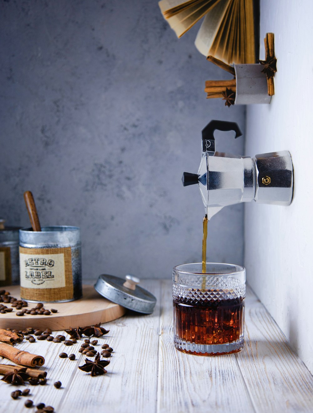 a cup of coffee being poured into a glass