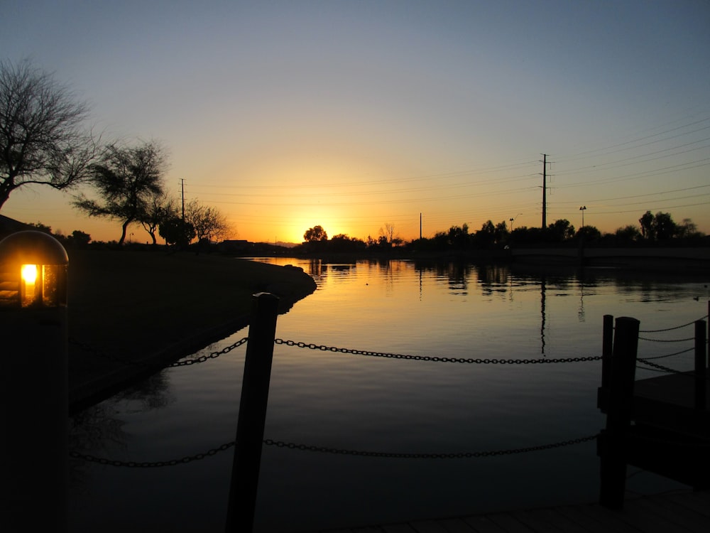 the sun is setting over a body of water