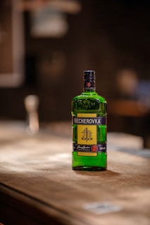 a bottle of alcohol sitting on top of a wooden table