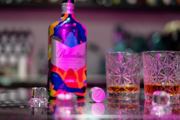 Vibrant vodka bottle glowing under soft red neon lights with ice cubes around
