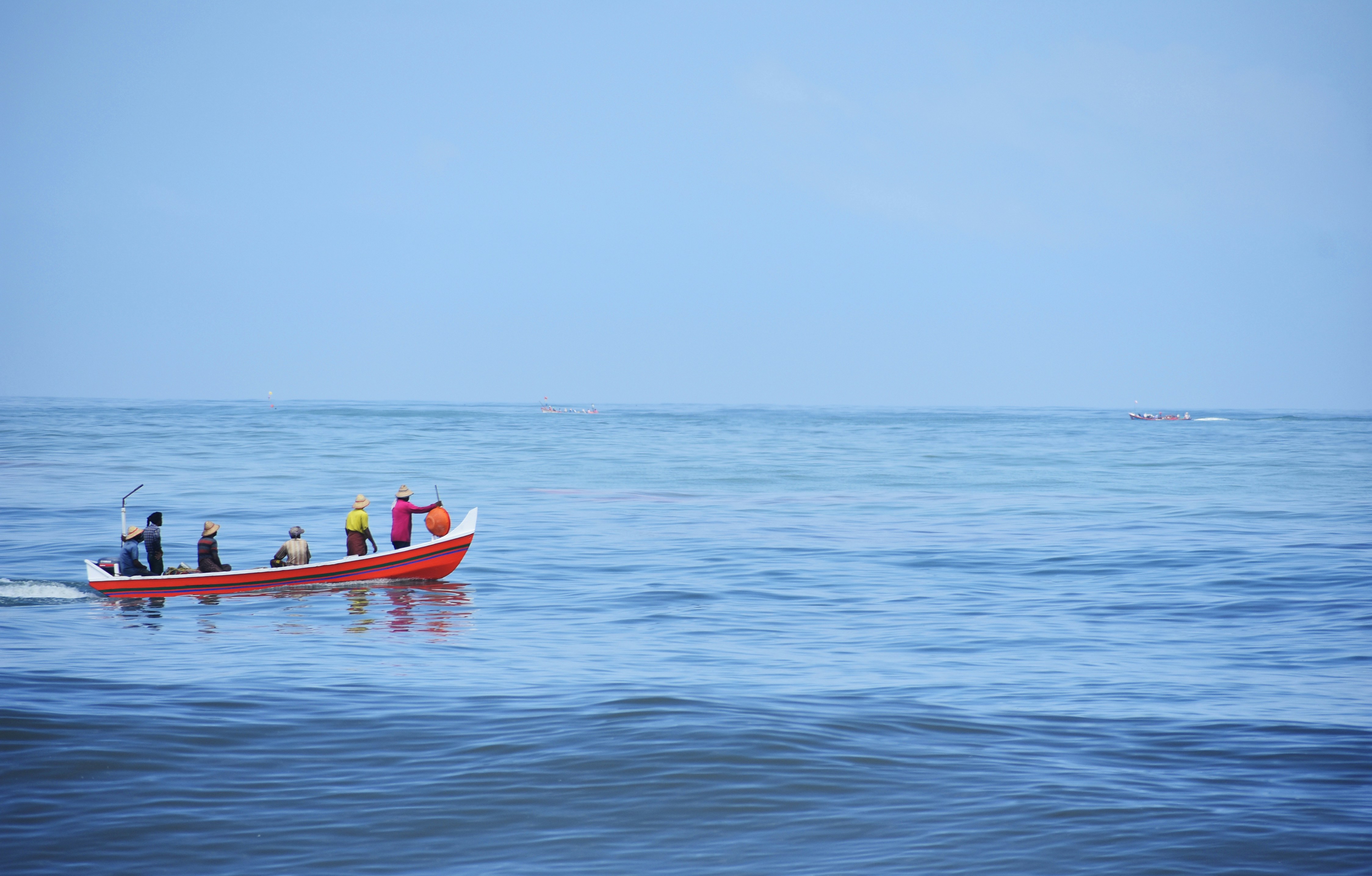 a group of people on a boat in the ocean