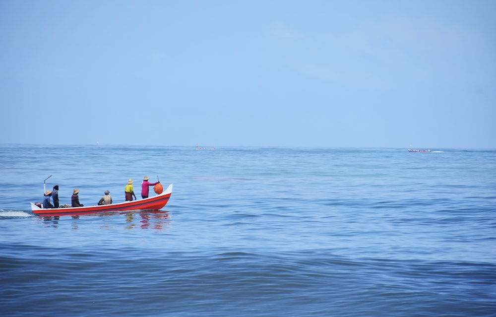 a group of people on a boat in the ocean