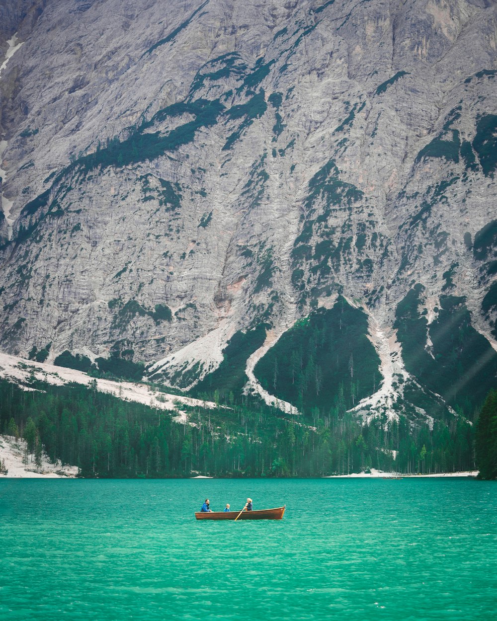 a boat in the water with a mountain in the background