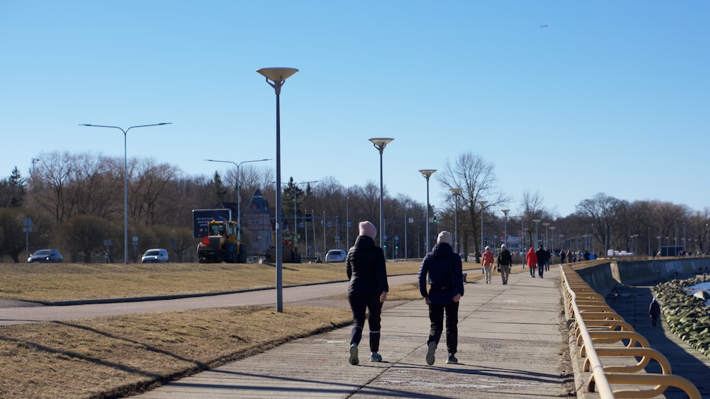 a couple of people that are walking down a sidewalk