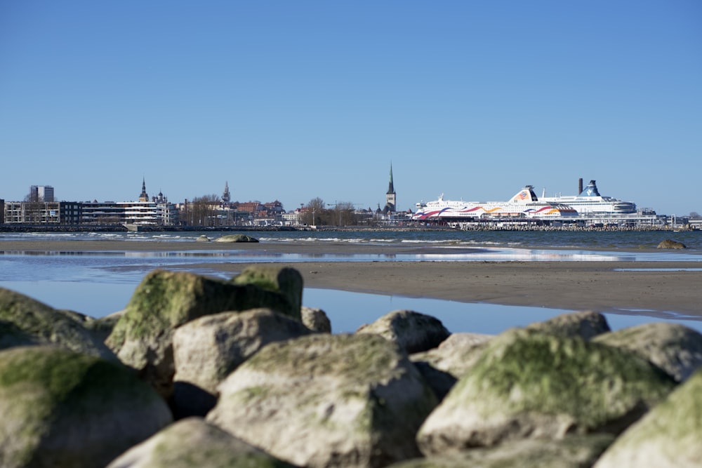 a large cruise ship is in the distance on the water