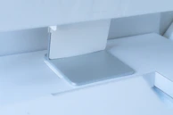 Close-up of the minimalist desk’s smooth surface and finely crafted edges, showcasing quality materials.