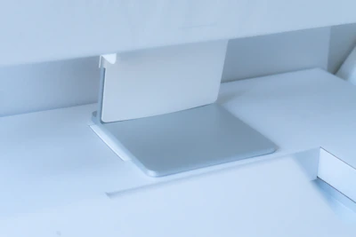 Close-up of a minimalist desk corner showing smooth surface and subtle metal accents.