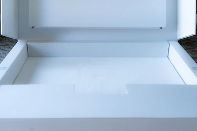 A clean, white packaging tray with precise compartments, styled with subtle plastic textures.