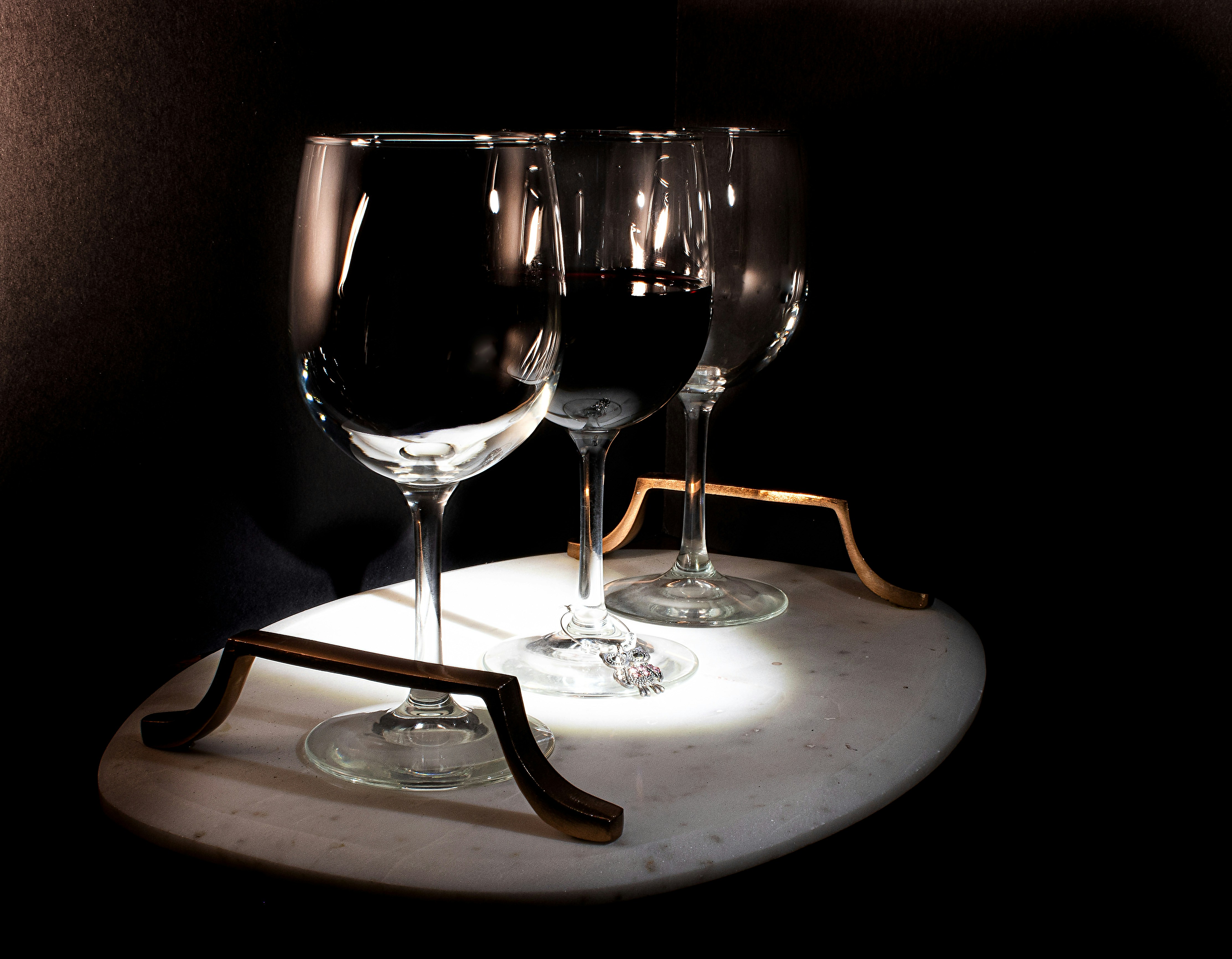 three wine glasses sitting on top of a table