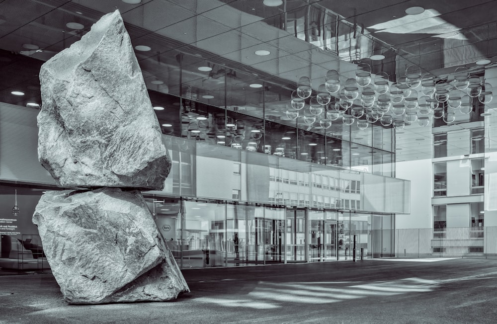 a large rock sitting in front of a building