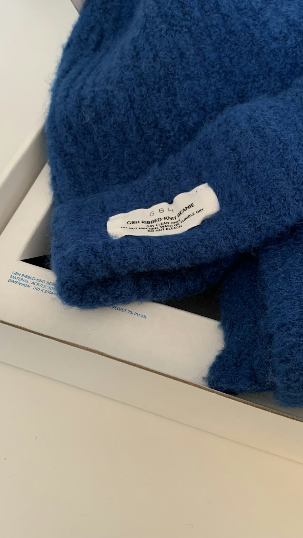 a close up of a blue towel on a white surface