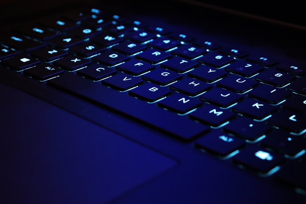 a close up of a keyboard with a blue light