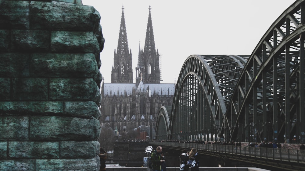 a group of people standing on top of a bridge