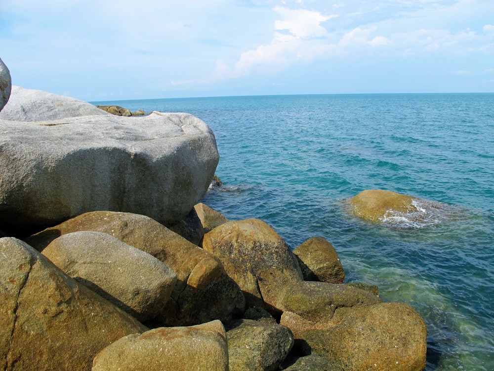 a rocky shore line with a body of water