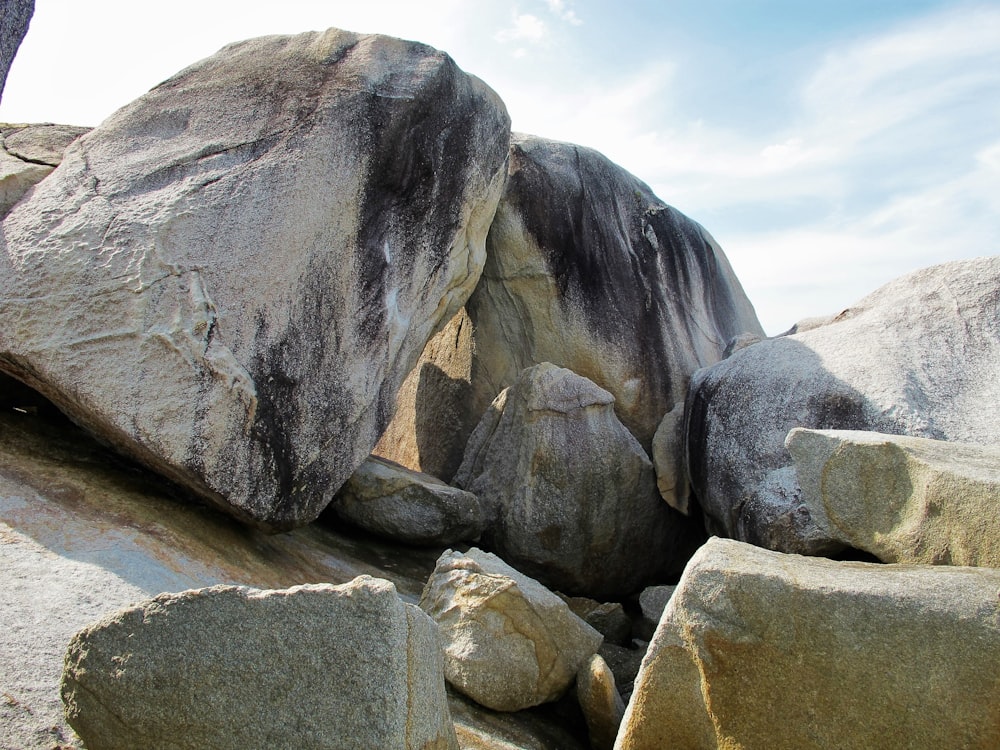 a large rock formation with a sky in the background