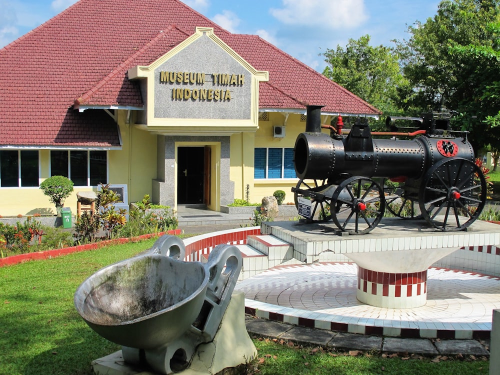 a museum building with a large metal bowl in front of it