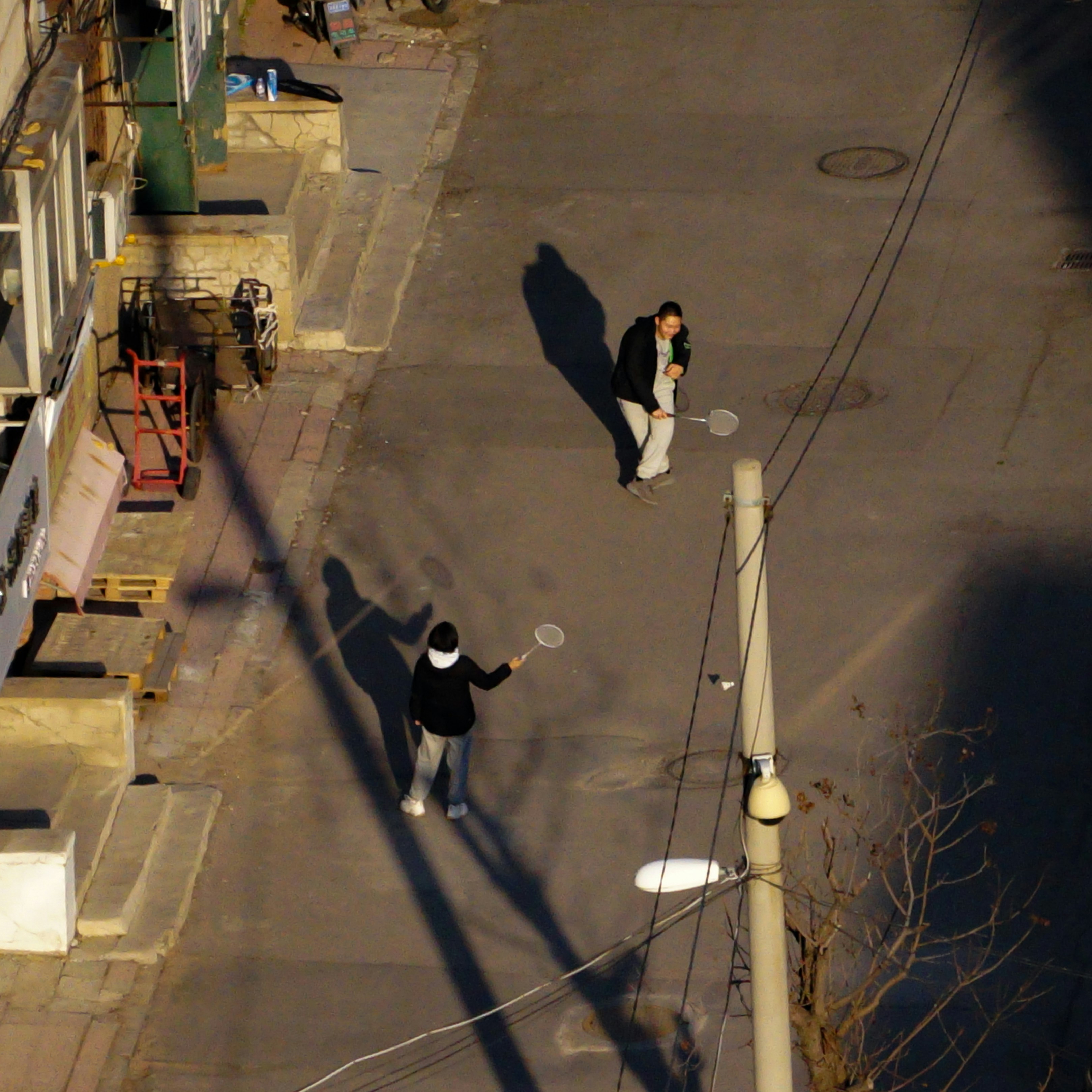 a couple of people that are standing in the street