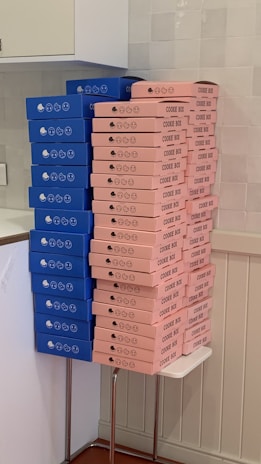 Stacks of colorful biscuit packs neatly arranged in a bustling Lagos warehouse.