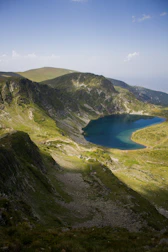 a mountain with a lake in the middle of it