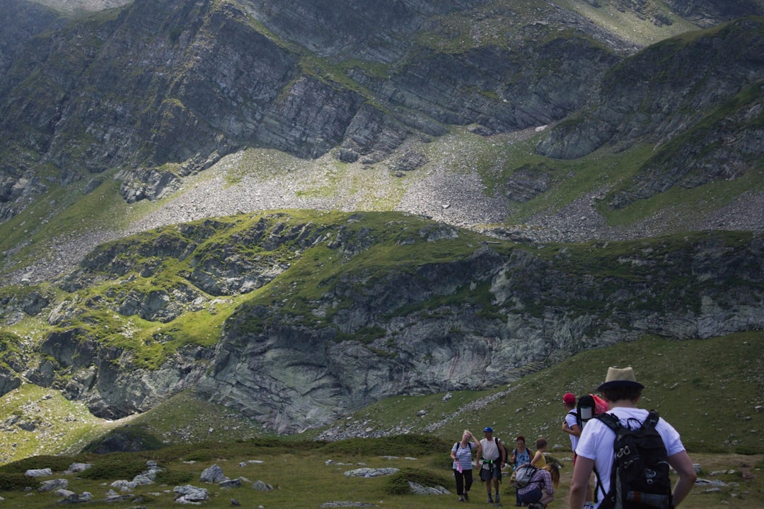 a group of people hiking up a mountain,