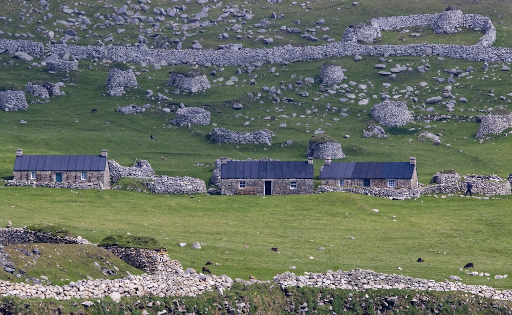 an old stone house in a green field