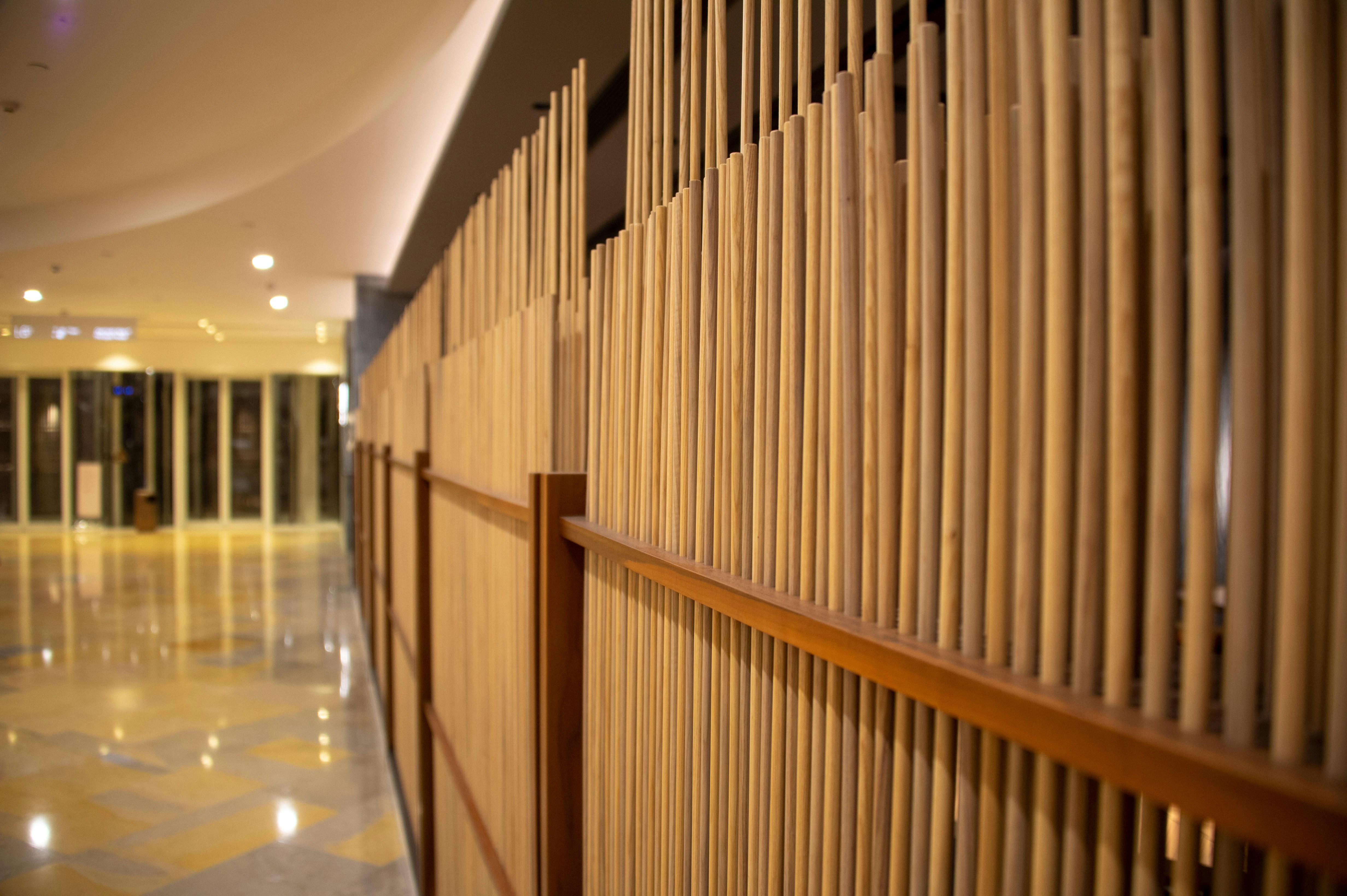 a hallway with a wall made of bamboo sticks