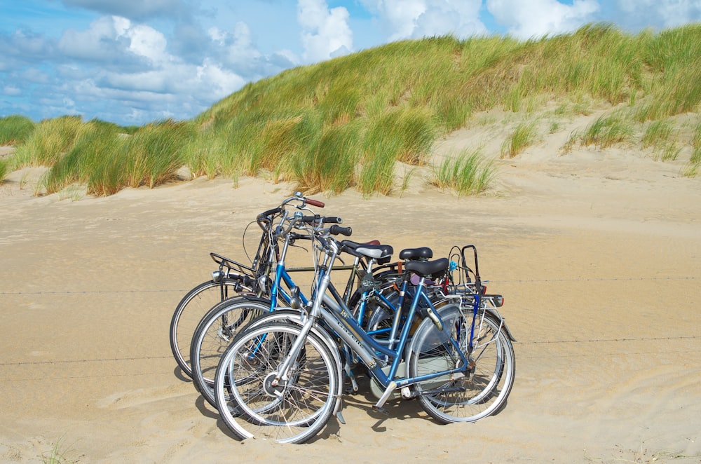 a couple of bikes that are sitting in the sand