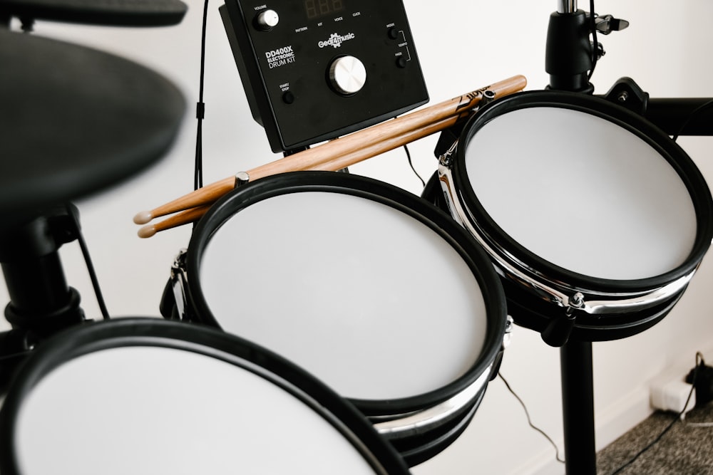 a close up of a drum set with sticks