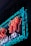 Neon sign featuring stylized characters in vibrant red and blue lights, set against a dark background. The illumination creates a bright and striking contrast.