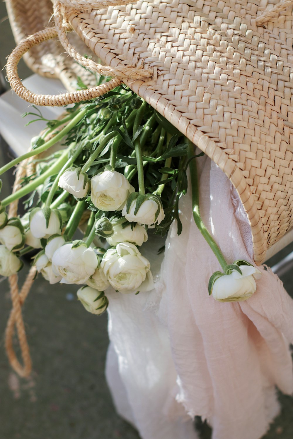 a bouquet of white flowers and a straw hat