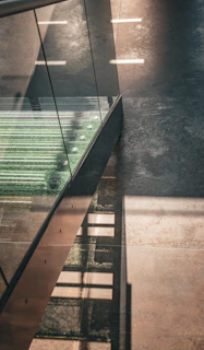 Close-up of bronze and gold accents on a modern staircase with layered transparent geometric effects.
