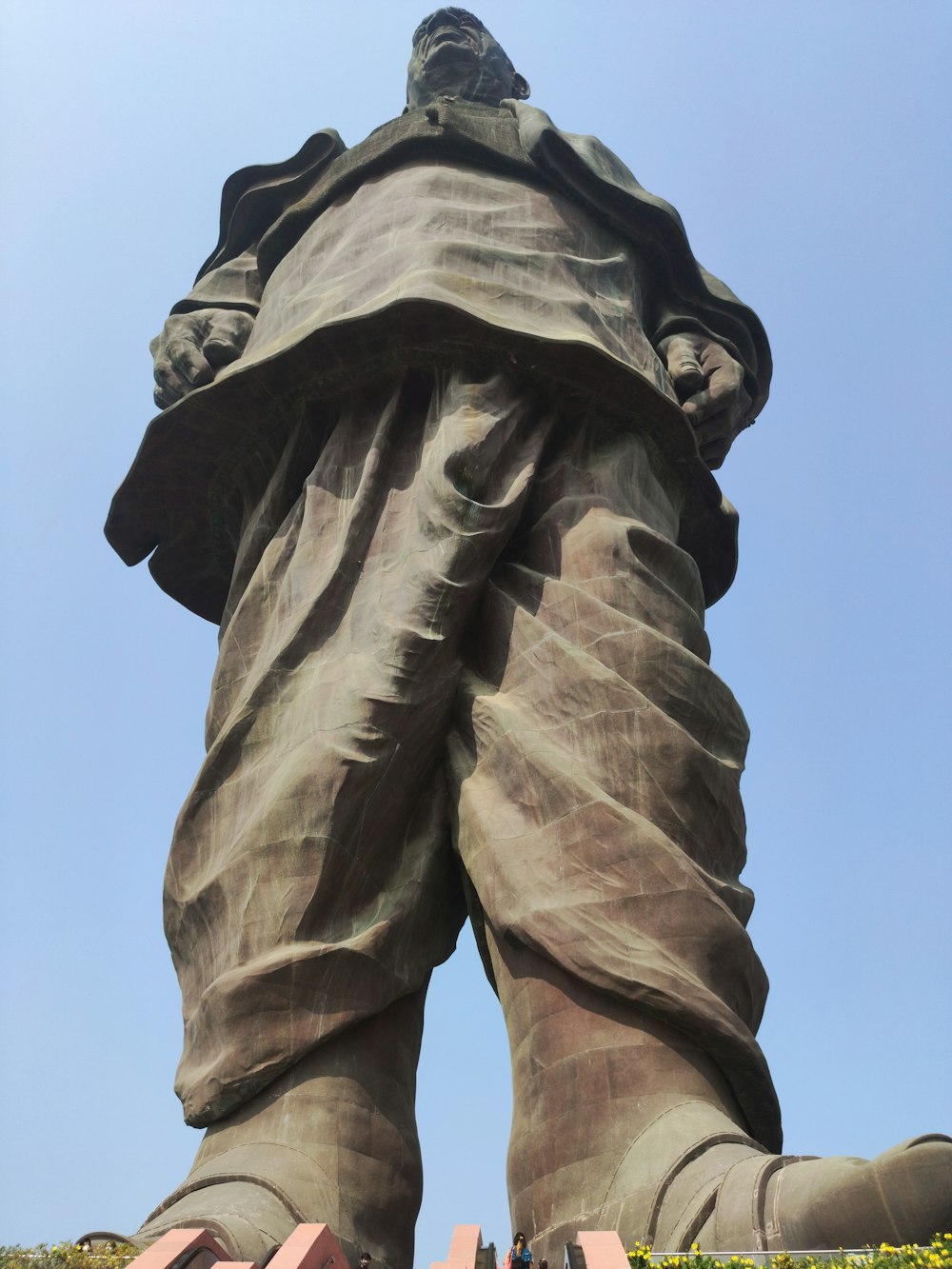 a large statue of a man with his hands in his pockets