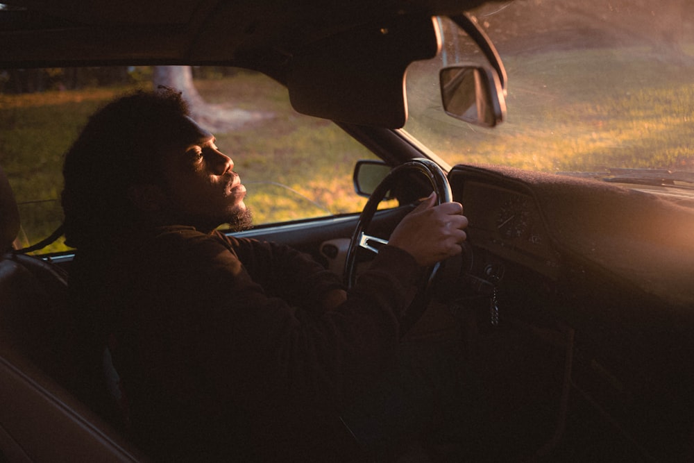 a man driving a car in the dark