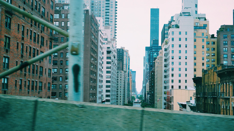 Cityscape with modern and older buildings, tall skyscraper on right side of frame