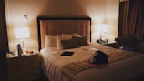 a bedroom with a bed and a night stand