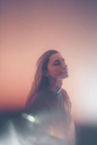 A serene portrait of Gisele Freitas, the author, smiling gently in a cozy setting.