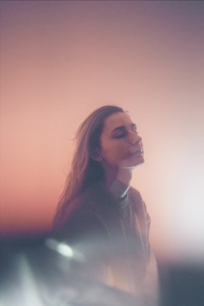 A serene portrait of a person smiling in natural light.