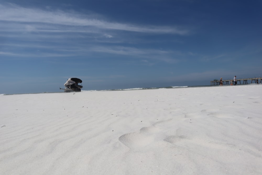 a boat sitting on top of a sandy beach