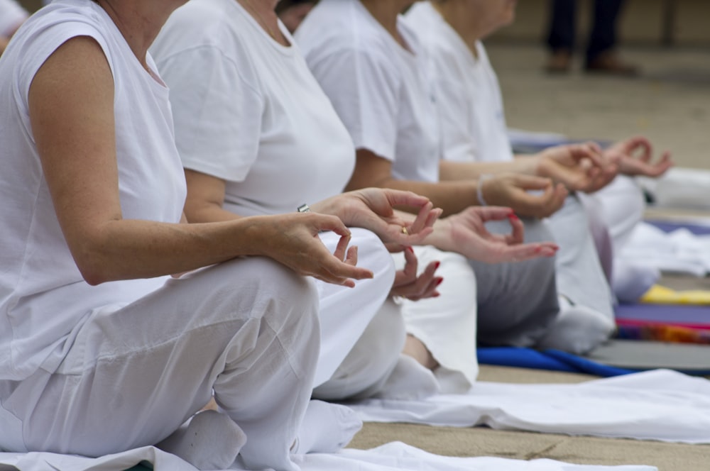a group of people sitting on the ground doing yoga