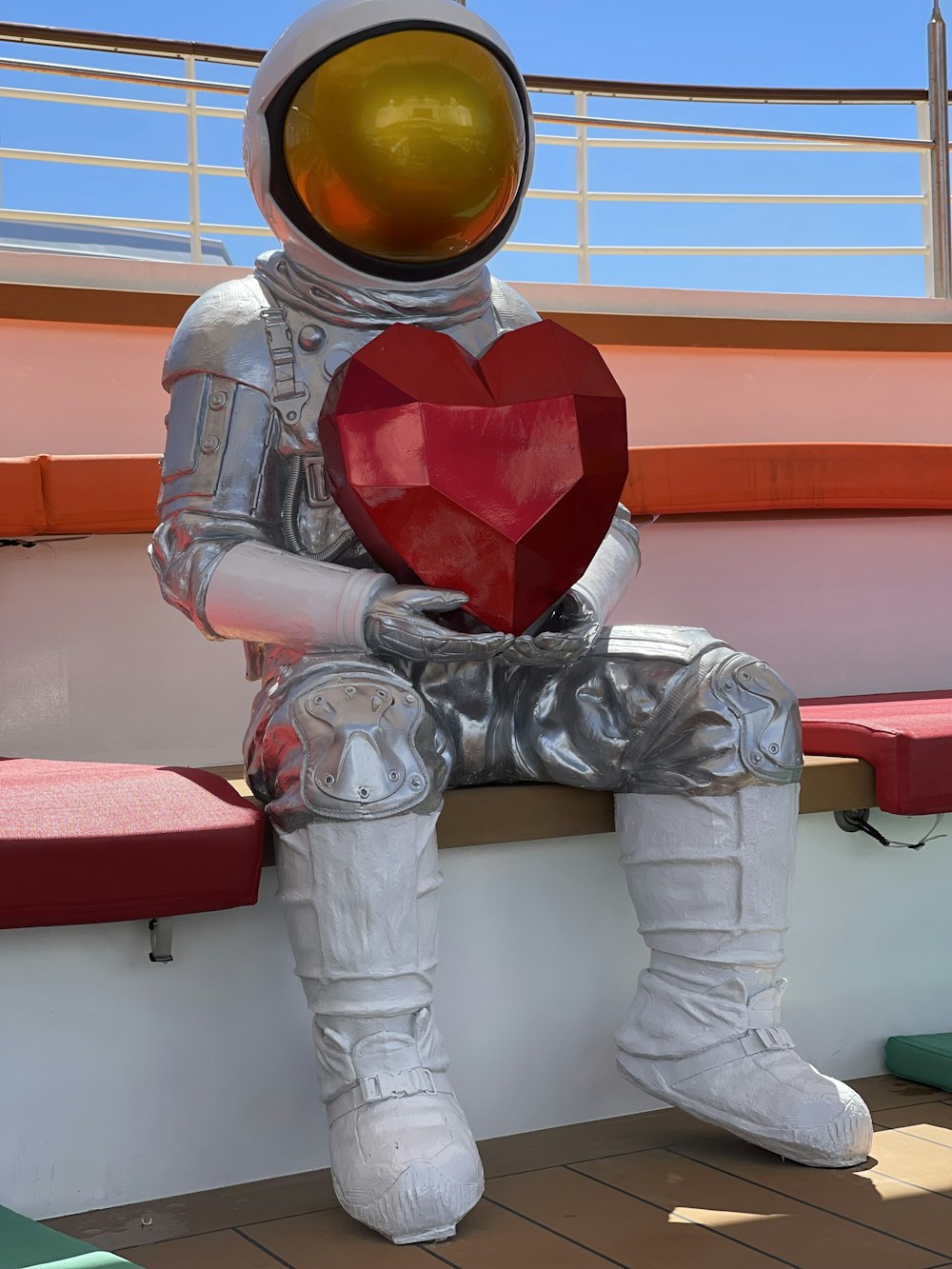 an astronaut sitting on a bench holding a heart