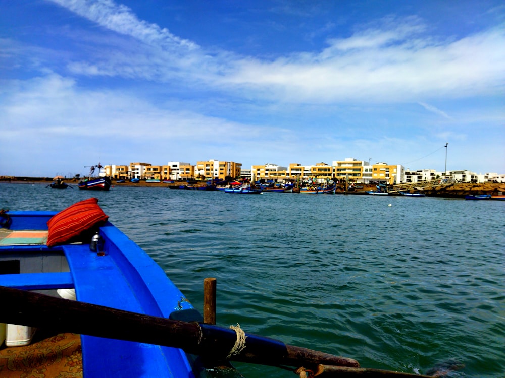 a blue boat sitting on top of a body of water