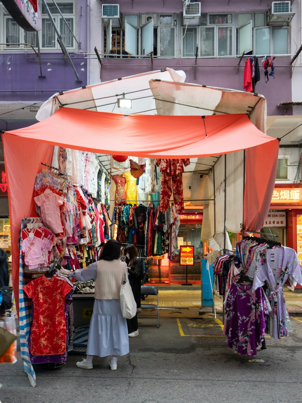 a woman standing in front of a store