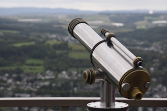 a telescope sitting on top of a metal pole