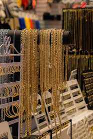 a rack of gold jewelry in a store