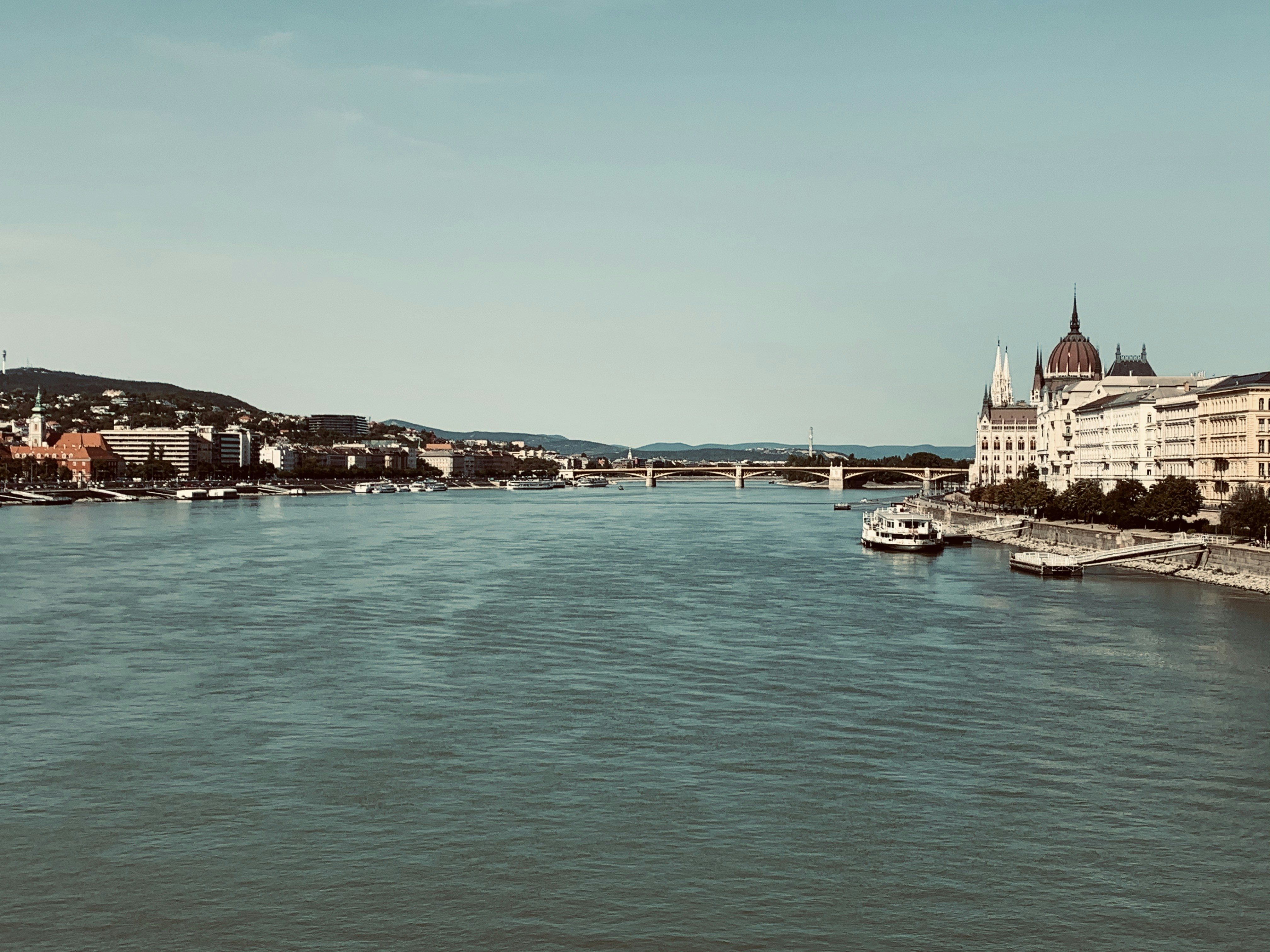 a view of a river with a bridge in the background